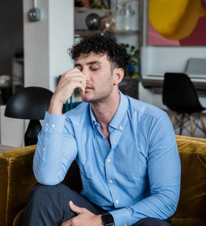 a man stressed out on his couch