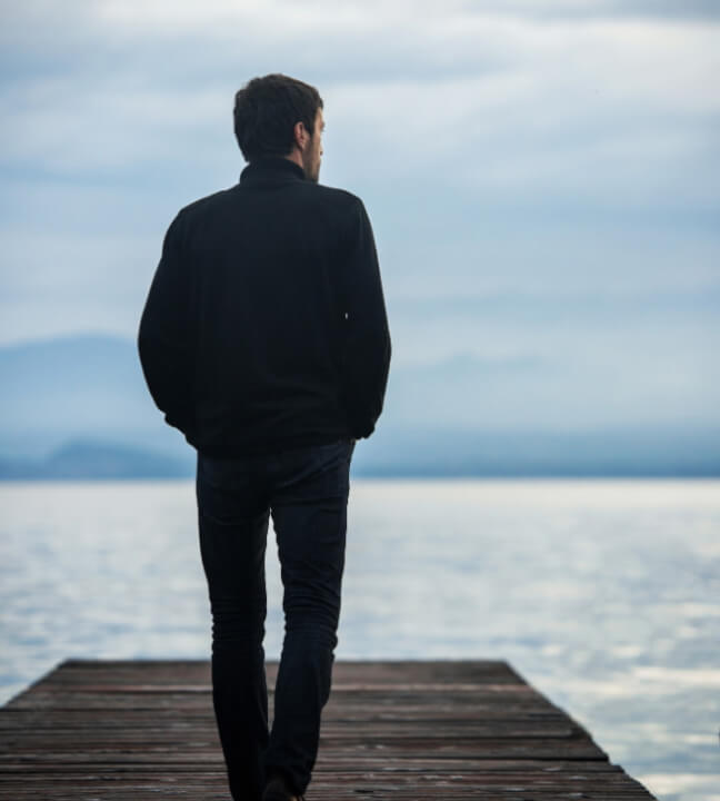 a man standing alone on a dock